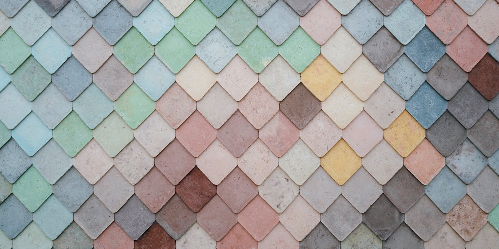 a multicolored tile wall with a pattern of small squares